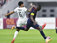 Paulo Silva (L) of Al-Sadd SC battles for the ball with Almoez Abdulla (R) of Duhail SC during the Ooredoo Qatar Stars League 24/25 match be...