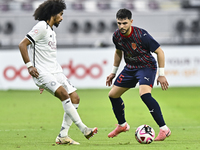 Akram Hassan Afif (L) of Al-Sadd SC battles for the ball with Bassam Hisham (R) of Duhail SC during the Ooredoo Qatar Stars League 24/25 mat...