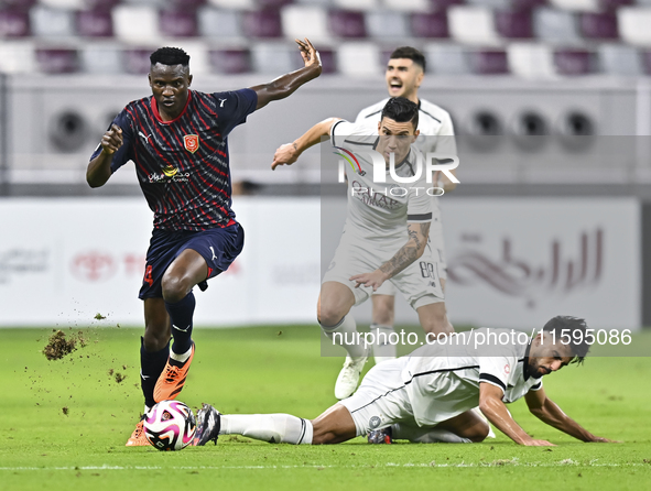 Tarek Salman of Al-Sadd SC battles for the ball with Michael Olunga during the Ooredoo Qatar Stars League 24/25 match between Al-Sadd SC and...