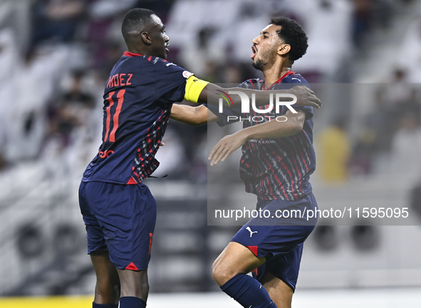 Homam El Amin (R) of Al Duhail SC celebrates after scoring a goal during the Ooredoo Qatar Stars League 24/25 match between Al-Sadd SC and A...