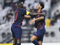 Homam El Amin (R) of Al Duhail SC celebrates after scoring a goal during the Ooredoo Qatar Stars League 24/25 match between Al-Sadd SC and A...