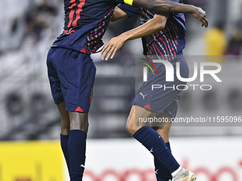 Homam El Amin (R) of Al Duhail SC celebrates after scoring a goal during the Ooredoo Qatar Stars League 24/25 match between Al-Sadd SC and A...