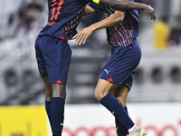 Homam El Amin (R) of Al Duhail SC celebrates after scoring a goal during the Ooredoo Qatar Stars League 24/25 match between Al-Sadd SC and A...