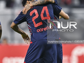 Edmilson Junior Paulo (R) of Al Duhail SC celebrates after scoring the second goal during the Ooredoo Qatar Stars League 24/25 match between...