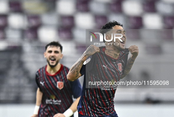 Edmilson Junior Paulo (R) of Al Duhail SC celebrates after scoring the second goal during the Ooredoo Qatar Stars League 24/25 match between...