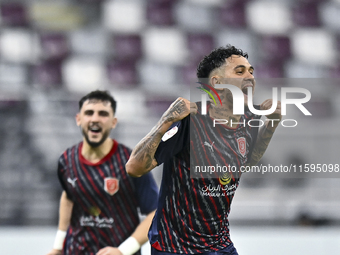 Edmilson Junior Paulo (R) of Al Duhail SC celebrates after scoring the second goal during the Ooredoo Qatar Stars League 24/25 match between...