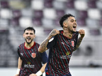 Edmilson Junior Paulo (R) of Al Duhail SC celebrates after scoring the second goal during the Ooredoo Qatar Stars League 24/25 match between...