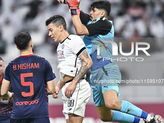 Andres Villa (C) of Al-Sadd SC battles for the ball with Salah Zachariah (R) of Duhail SC during the Ooredoo Qatar Stars League 24/25 match...