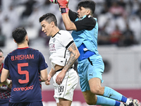 Andres Villa (C) of Al-Sadd SC battles for the ball with Salah Zachariah (R) of Duhail SC during the Ooredoo Qatar Stars League 24/25 match...