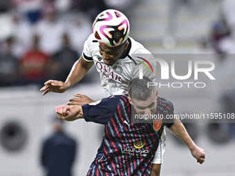 Pedro Miguel Correia (L) of Al-Sadd SC battles for the ball with Benjamin Bourigeaud (R) of Duhail SC during the Ooredoo Qatar Stars League...