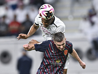 Pedro Miguel Correia (L) of Al-Sadd SC battles for the ball with Benjamin Bourigeaud (R) of Duhail SC during the Ooredoo Qatar Stars League...