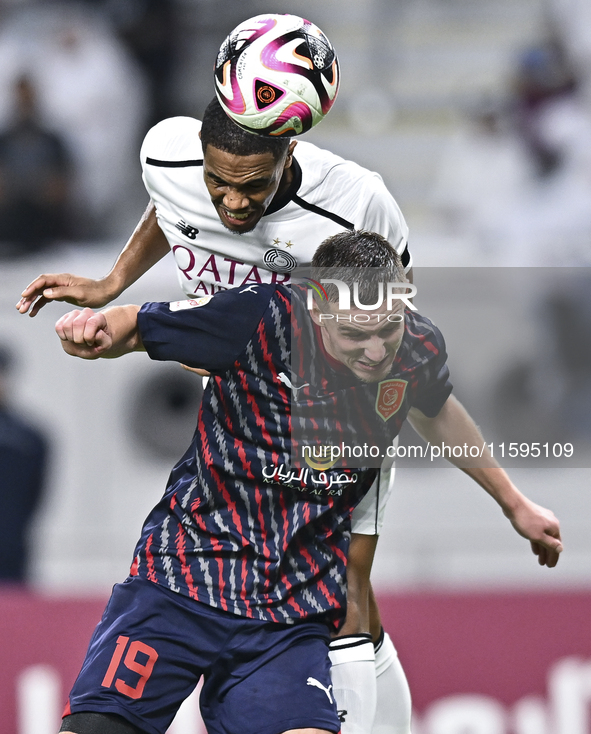 Pedro Miguel Correia (L) of Al-Sadd SC battles for the ball with Benjamin Bourigeaud (R) of Duhail SC during the Ooredoo Qatar Stars League...