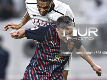 Pedro Miguel Correia (L) of Al-Sadd SC battles for the ball with Benjamin Bourigeaud (R) of Duhail SC during the Ooredoo Qatar Stars League...