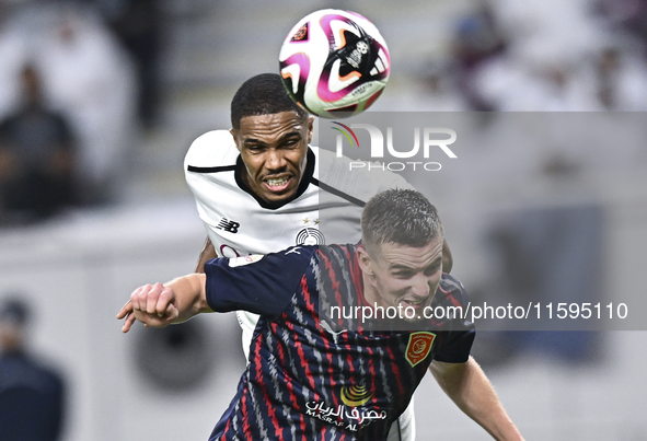 Pedro Miguel Correia (L) of Al-Sadd SC battles for the ball with Benjamin Bourigeaud (R) of Duhail SC during the Ooredoo Qatar Stars League...