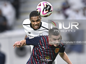 Pedro Miguel Correia (L) of Al-Sadd SC battles for the ball with Benjamin Bourigeaud (R) of Duhail SC during the Ooredoo Qatar Stars League...