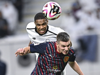 Pedro Miguel Correia (L) of Al-Sadd SC battles for the ball with Benjamin Bourigeaud (R) of Duhail SC during the Ooredoo Qatar Stars League...