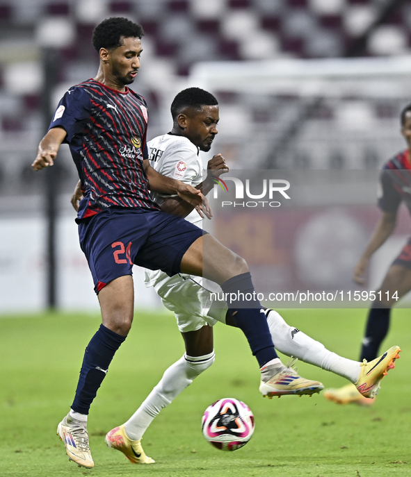 Musaab Khidir Mohamed (R) of Al-Sadd SC battles for the ball with Homam El Amin (L) of Duhail SC during the Ooredoo Qatar Stars League 24/25...