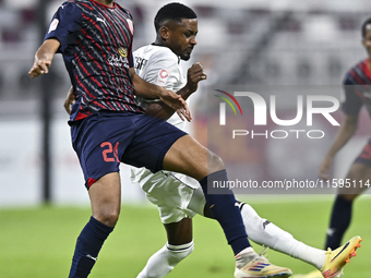 Musaab Khidir Mohamed (R) of Al-Sadd SC battles for the ball with Homam El Amin (L) of Duhail SC during the Ooredoo Qatar Stars League 24/25...