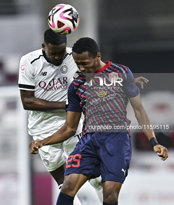 Musaab Khidir Mohamed (L) of Al-Sadd SC battles for the ball with Rashid Abdullah (R) of Duhail SC during the Ooredoo Qatar Stars League 24/...