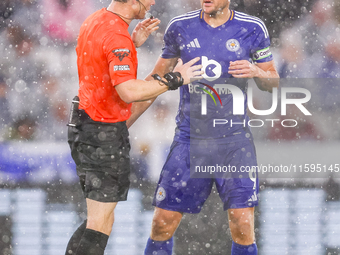 Referee Darren England speaks to #9, Jamie Vardy of Leicester City during the Premier League match between Leicester City and Everton at the...