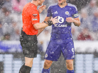 Referee Darren England speaks to #9, Jamie Vardy of Leicester City during the Premier League match between Leicester City and Everton at the...