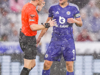 Referee Darren England speaks to #9, Jamie Vardy of Leicester City during the Premier League match between Leicester City and Everton at the...