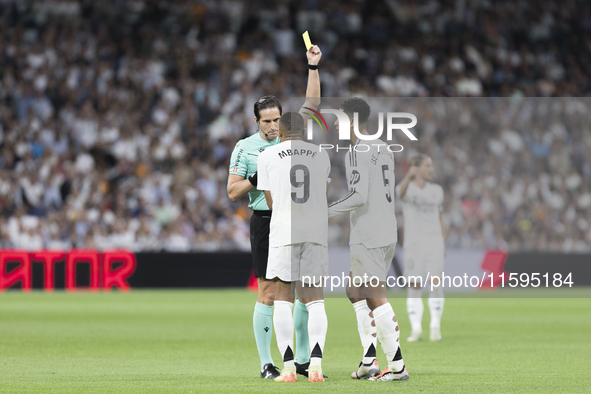 Kylian Mbappe of Real Madrid receives a yellow card during the La Liga 2024/25 match between Real Madrid and Espanyol at Santiago Bernabeu S...