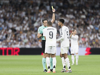 Kylian Mbappe of Real Madrid receives a yellow card during the La Liga 2024/25 match between Real Madrid and Espanyol at Santiago Bernabeu S...