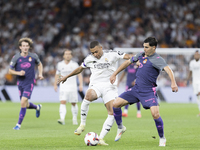 Kylian Mbappe of Real Madrid and Alvaro Tejero of Espanyol fight for the ball during the La Liga 2024/25 match between Real Madrid and Espan...