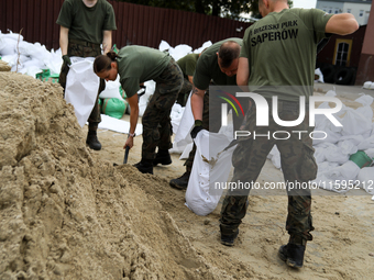 Soldiers from the 1st Brzeg Sapper Regiment prepare sandbags during flooding due to the Odra River flooding in Brzeg, Poland, on September 1...