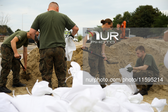 Soldiers from the 1st Brzeg Sapper Regiment prepare sandbags during flooding due to the Odra River flooding in Brzeg, Poland, on September 1...