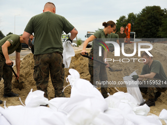 Soldiers from the 1st Brzeg Sapper Regiment prepare sandbags during flooding due to the Odra River flooding in Brzeg, Poland, on September 1...