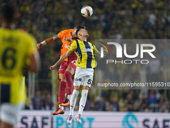 Abdülkerim Bardakcı of Galatasaray and Sebastian Szymański of Fenerbahce battle for the ball during the Turkey Süper Ligue Round 5 between F...