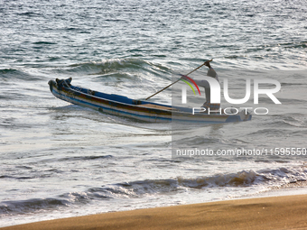 A fisherman paddles a fishing boat into the ocean along Paruthiyoor Beach in Paruthiyoor, Kerala, India, on April 15, 2024. (