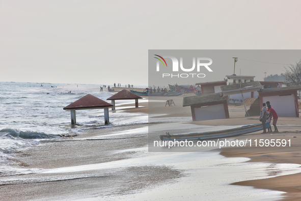 Fishermen push a fishing boat into the ocean along Paruthiyoor Beach in Paruthiyoor, Kerala, India, on April 15, 2024. 