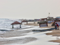 Fishermen push a fishing boat into the ocean along Paruthiyoor Beach in Paruthiyoor, Kerala, India, on April 15, 2024. (