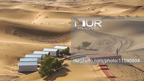 Tourists view the desert scenery at Jinshawan Desert tourism holiday camp in Zhangye, China, on September 21, 2024. 