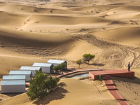 Tourists view the desert scenery at Jinshawan Desert tourism holiday camp in Zhangye, China, on September 21, 2024. (