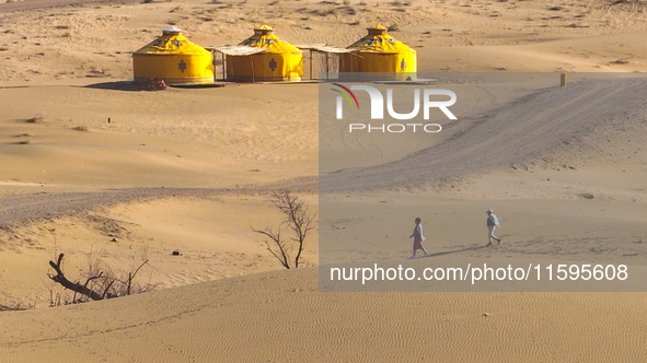 Visitors experience the life of a desert family at the Jinshawan Desert tourism holiday camp in Zhangye, China, on September 21, 2024. 