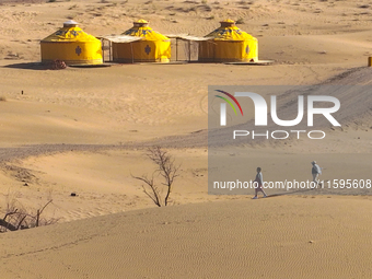 Visitors experience the life of a desert family at the Jinshawan Desert tourism holiday camp in Zhangye, China, on September 21, 2024. (