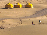 Visitors experience the life of a desert family at the Jinshawan Desert tourism holiday camp in Zhangye, China, on September 21, 2024. (