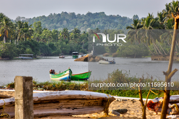 A river flows by the ocean along Paruthiyoor Beach in Paruthiyoor, Kerala, India, on April 15, 2024. 