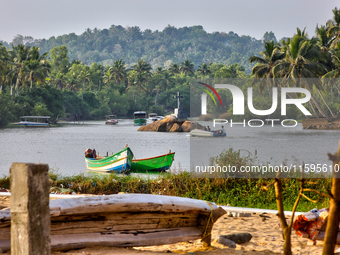 A river flows by the ocean along Paruthiyoor Beach in Paruthiyoor, Kerala, India, on April 15, 2024. (