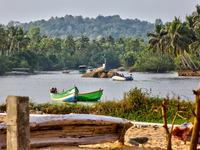 A river flows by the ocean along Paruthiyoor Beach in Paruthiyoor, Kerala, India, on April 15, 2024. (