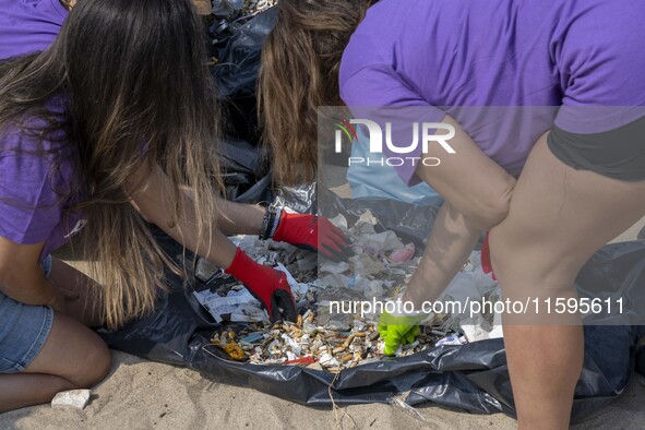 Volunteers sort the waste collected during a beach cleanup day in the municipality of Alges in Lisbon, Portugal, on September 21, 2024. The...