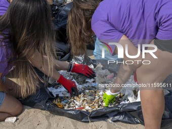 Volunteers sort the waste collected during a beach cleanup day in the municipality of Alges in Lisbon, Portugal, on September 21, 2024. The...