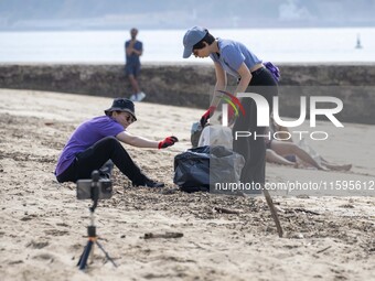 Several volunteers collect waste and garbage during a beach cleanup day in the municipality of Alges in Lisbon, Portugal, on September 21, 2...