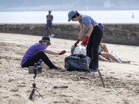 Several volunteers collect waste and garbage during a beach cleanup day in the municipality of Alges in Lisbon, Portugal, on September 21, 2...