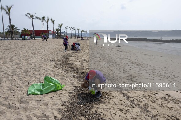 Several volunteers collect waste and garbage during a beach cleanup day in the municipality of Alges in Lisbon, Portugal, on September 21, 2...