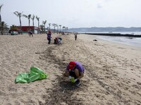 Several volunteers collect waste and garbage during a beach cleanup day in the municipality of Alges in Lisbon, Portugal, on September 21, 2...